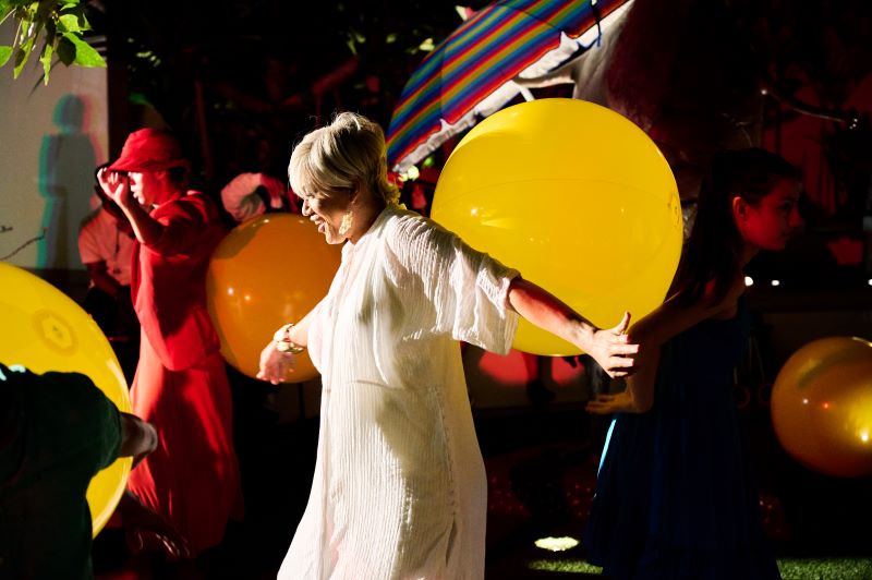 Performers with large yellow beach balls