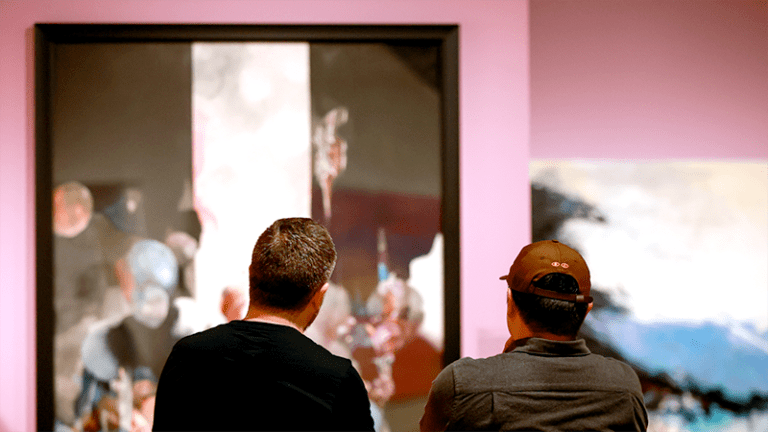 Museum visitors in gallery looking at wall art