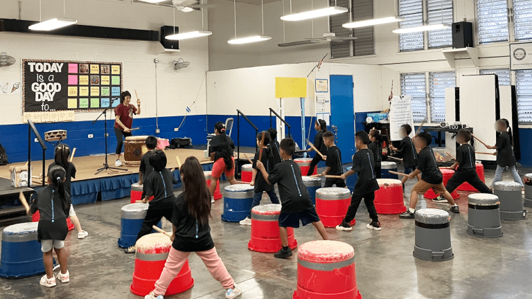 Students learning taiko drumming.