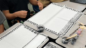 Table with bandanas being printed by students.