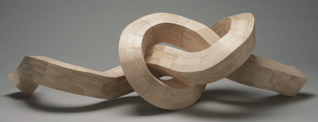 pieces of pine wood formed into a woven pattern and shaped into a knot
