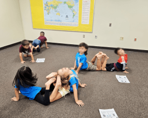 Children working in pairs bend and flex to make different shapes.